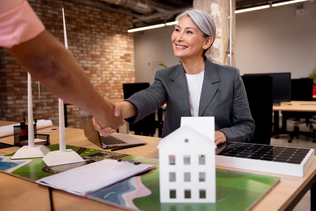 Business professionals shaking hands in an office after completing a commercial mortgage agreement